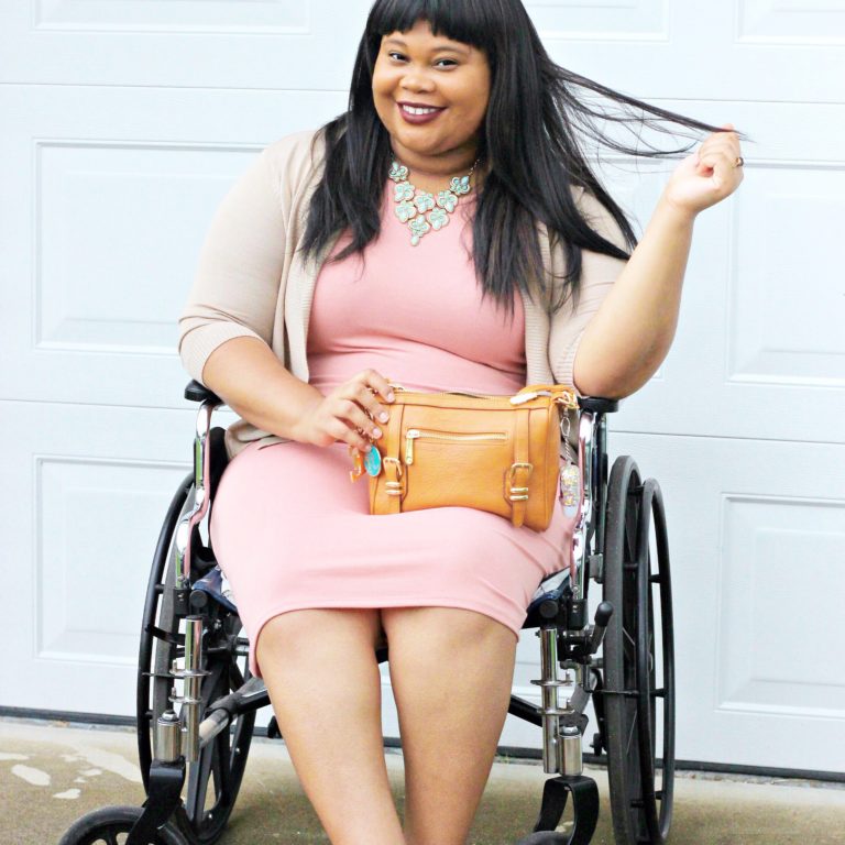 woman sitting on a wheelchair wearing a pink dress 