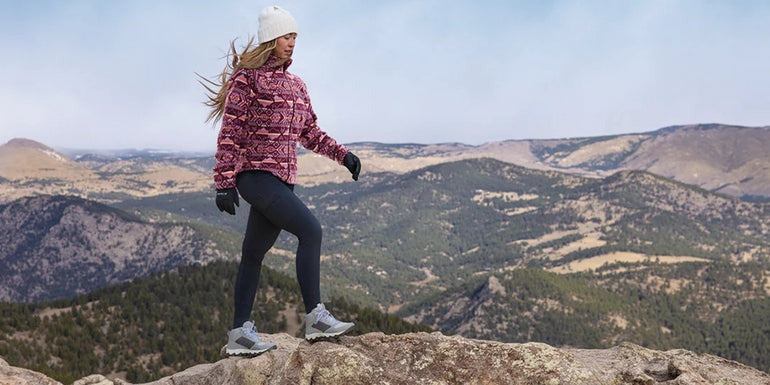 a girl on a rock climbing a mountain