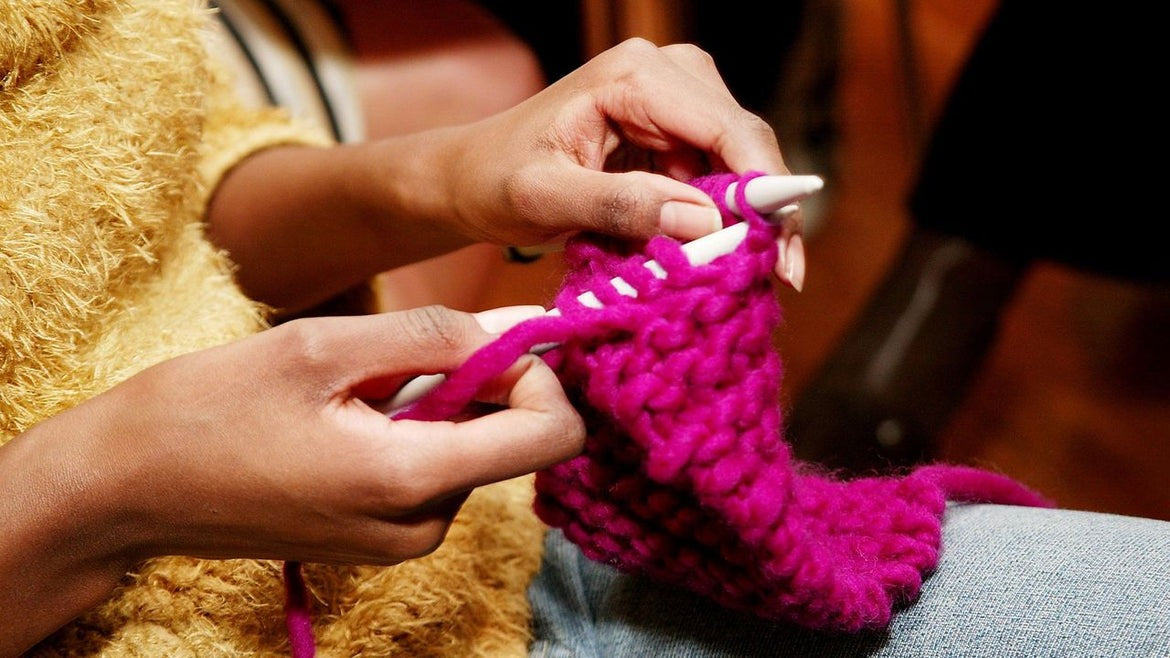 a woman holding a pair of scissors in her hand