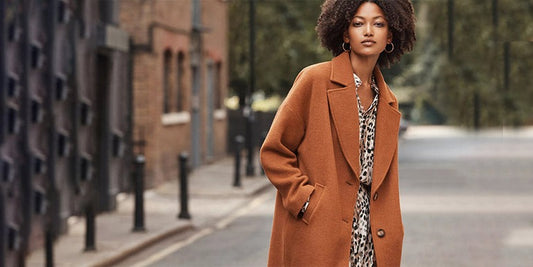 a woman walking down a street with a bag