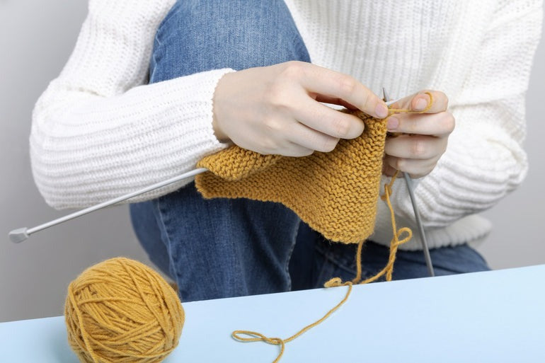 girl making sweater with yarn