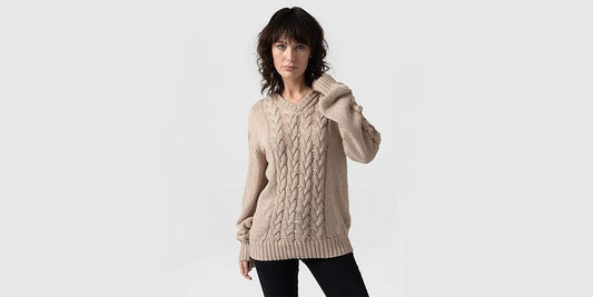 arafed woman in sweater and jeans posing for a picture