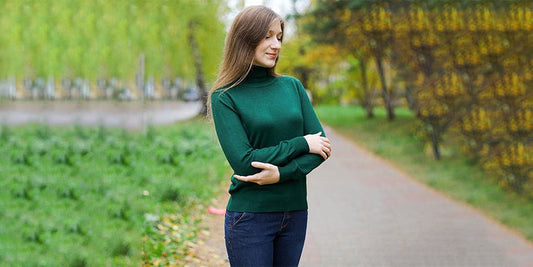 there is a woman standing on a path with her arms crossed