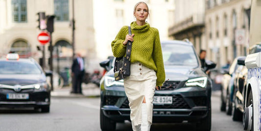 women walking infront of a car wearing green knitted switter