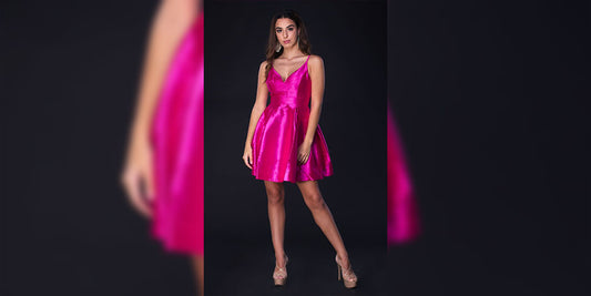 women wearing pink frock standing infront of a grey background