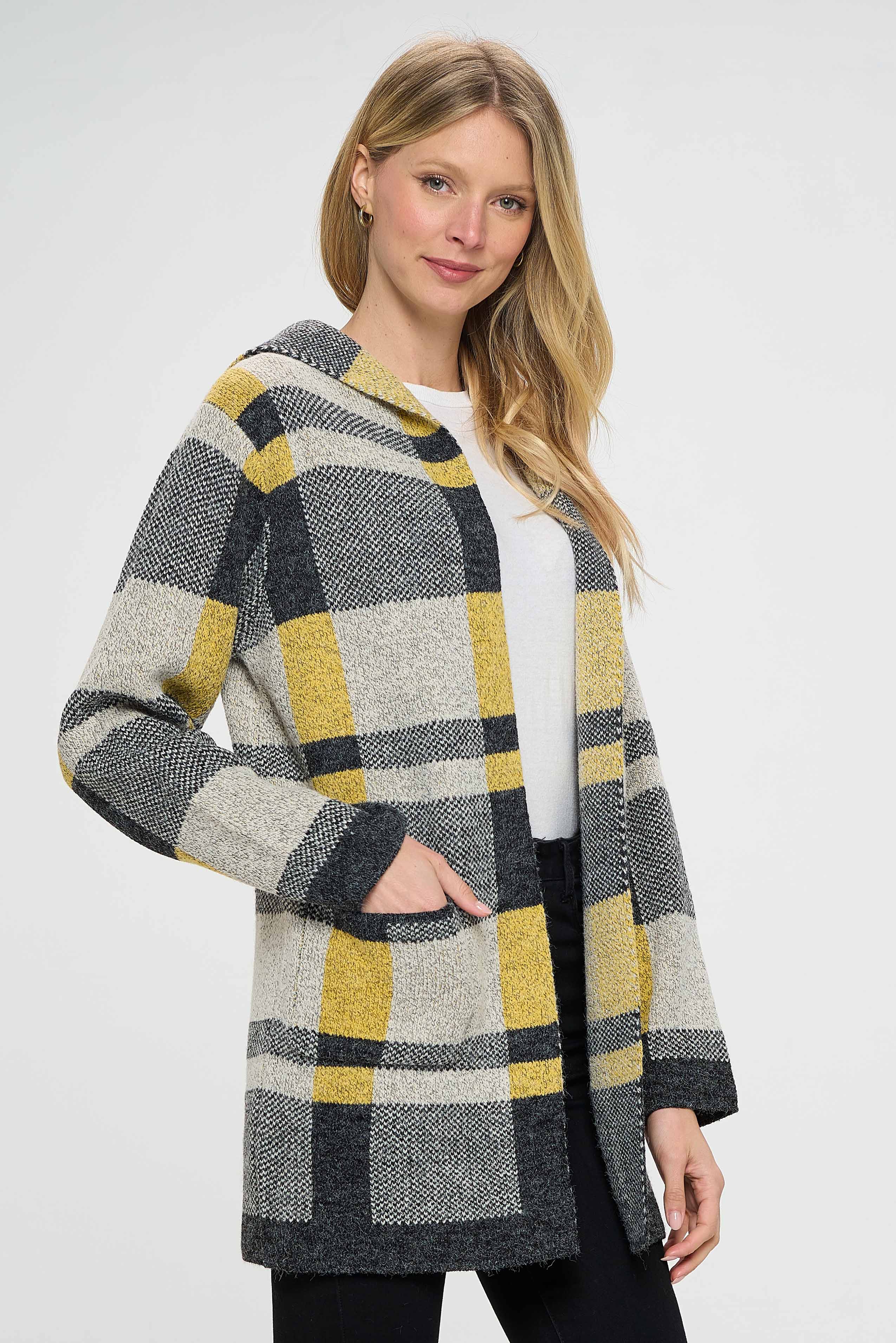 The gray, yellow, and black shades used in the plaid pattern create a cohesive and stylish look that can be paired with a variety of different clothing items. The pattern is bold and eye-catching, making it a statement piece that is sure to turn heads.  The pullover features pockets in the front, which provide a functional element to the garment. The pockets can be used to store small items such as keys or a phone, making it a convenient choice for on-the-go activities. 