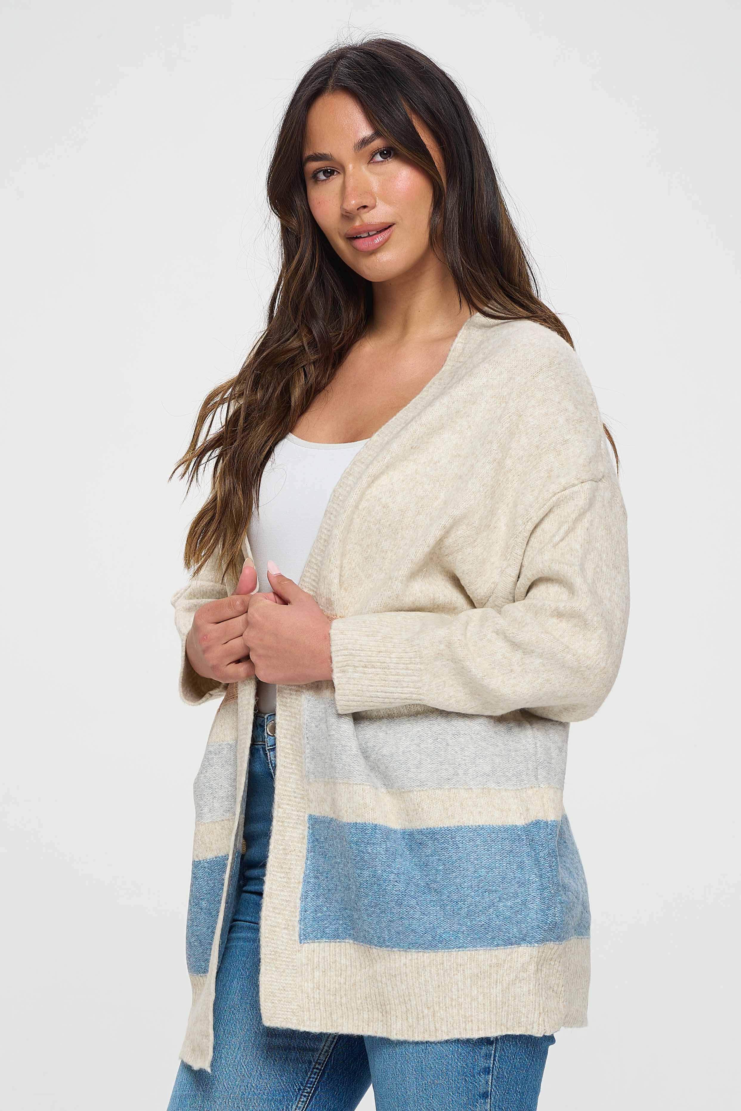 The long sleeves of the pullover provide coverage and warmth, while the medium length adds a comfortable and casual feel to the garment. The white color of the pullover creates a clean and classic look that is perfect for a variety of occasions.  The subtle shades of blue and orange stripes are arranged in a way that creates a flattering and feminine silhouette. 