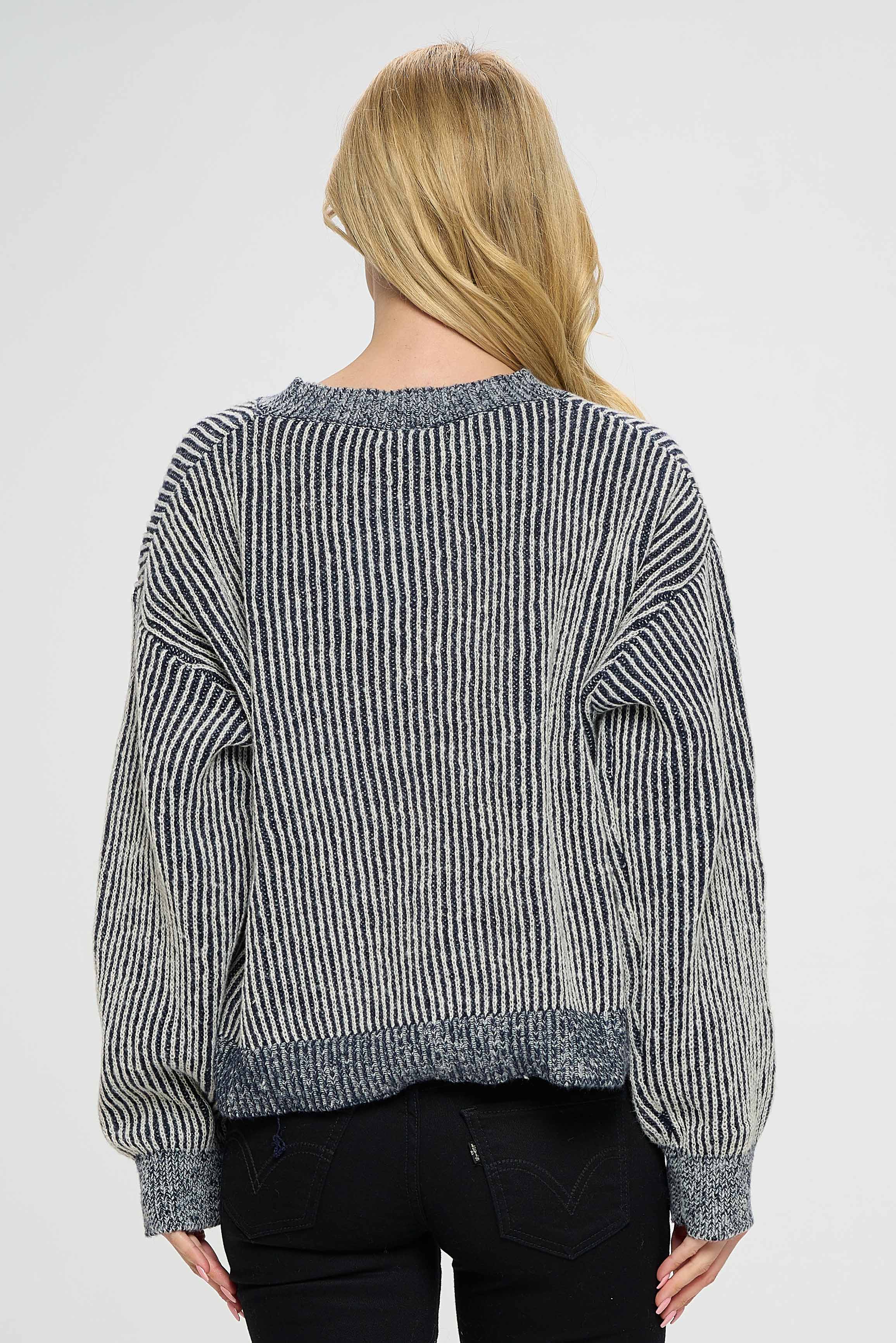 The sweater is perfect for pairing with jeans or leggings for a casual and comfortable look, while it can also be dressed up with a skirt or dress pants for a more formal occasion. Its versatility makes it a great addition to any wardrobe.