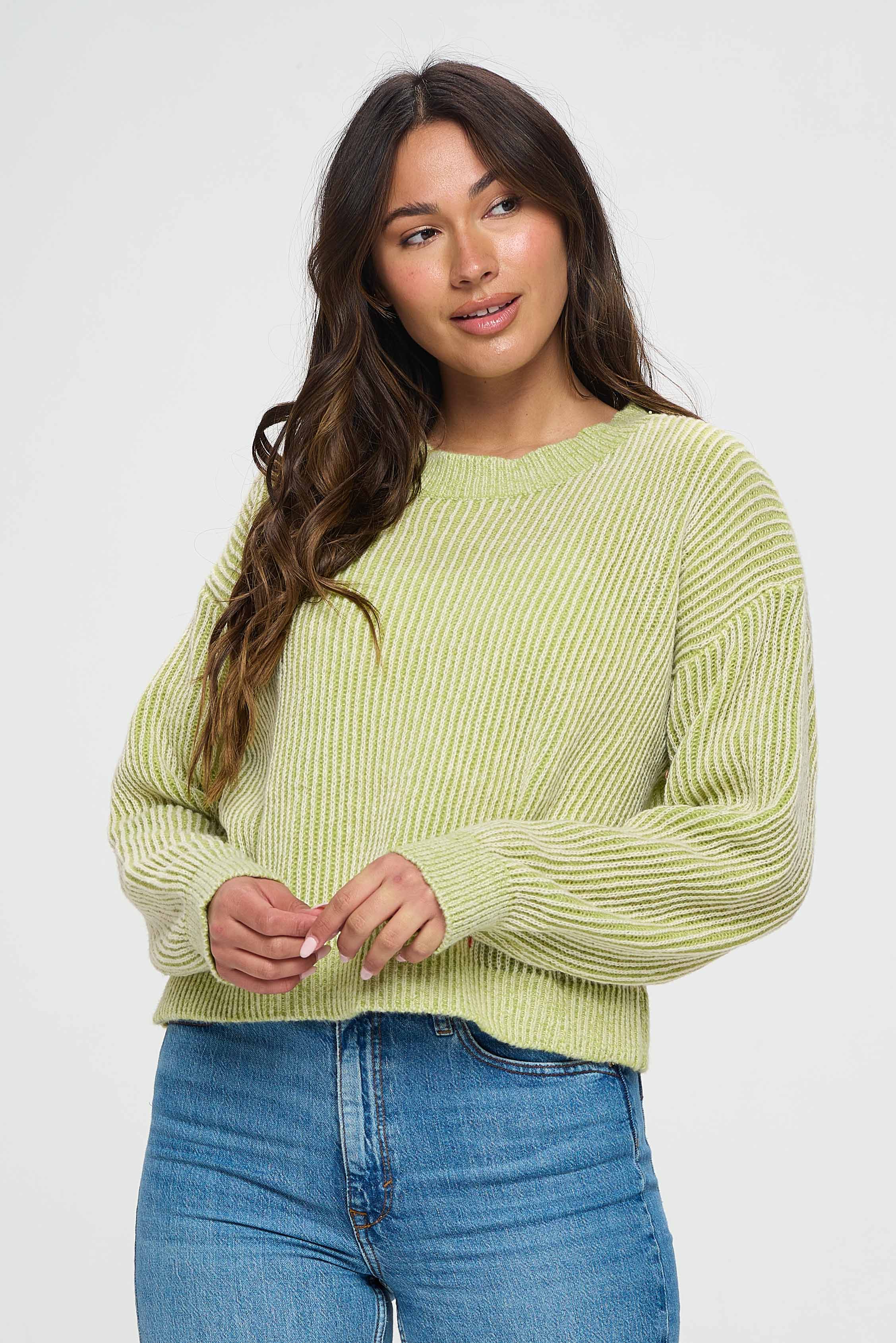 The short length of the sweater creates a playful and youthful feel to the garment, while the loose and relaxed fit makes it comfortable and easy to wear. The green shading on the sweater creates a sleek and modern look, making it perfect for dressing up or dressing down.