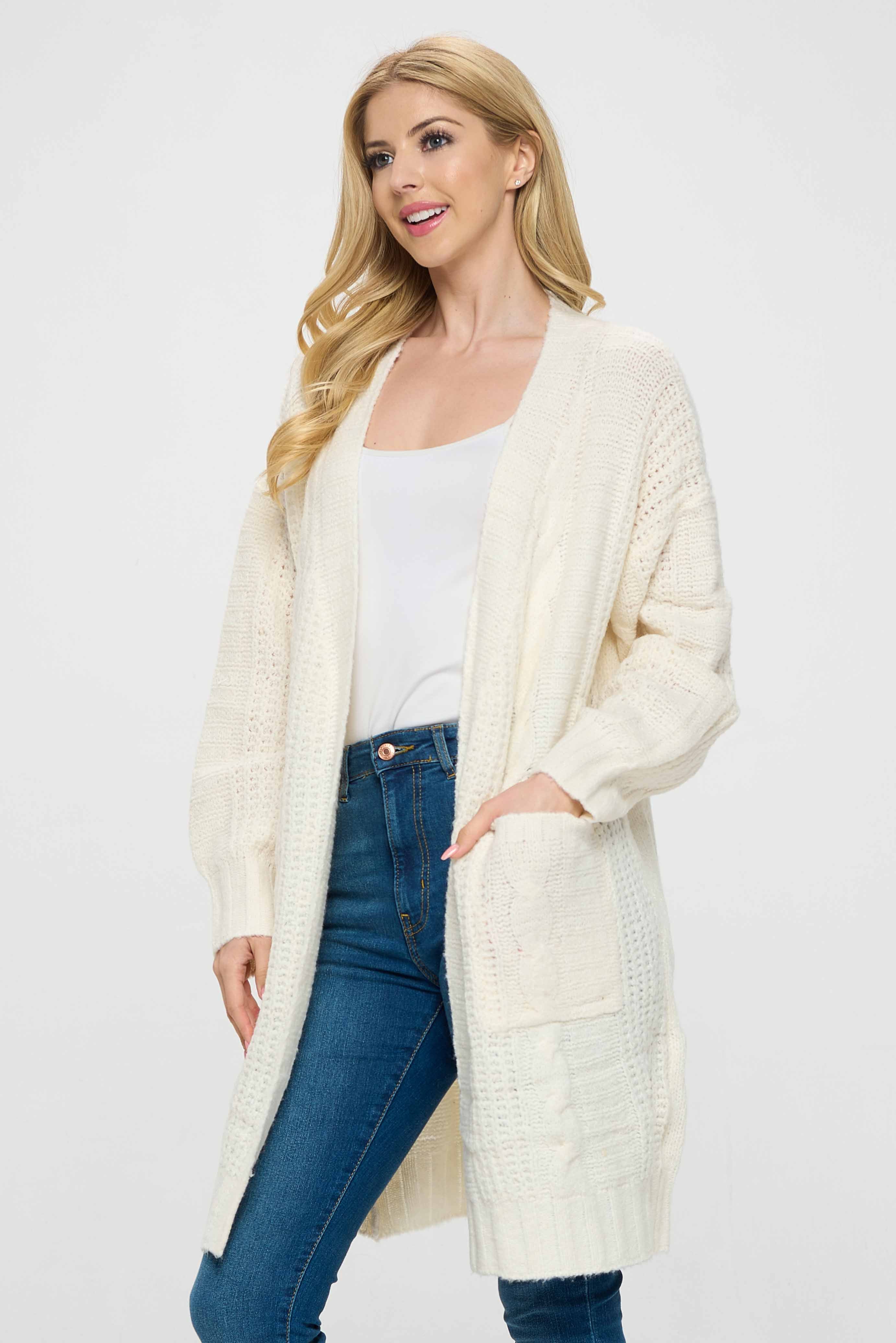 The front is open and has a long length, creating a comfortable and relaxed fit.  The sweater is white in color, creating a fresh and bright look, making it easy to pair with any outfit. The long length of the sweater provides added warmth and comfort, making it perfect for colder weather.